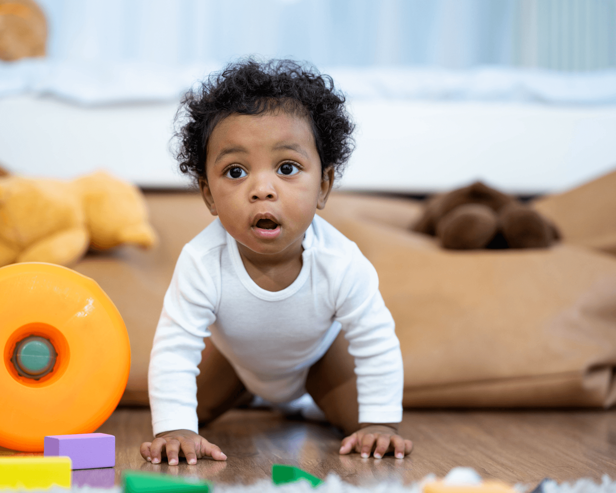 Baby boy crawling and playing with toys. 