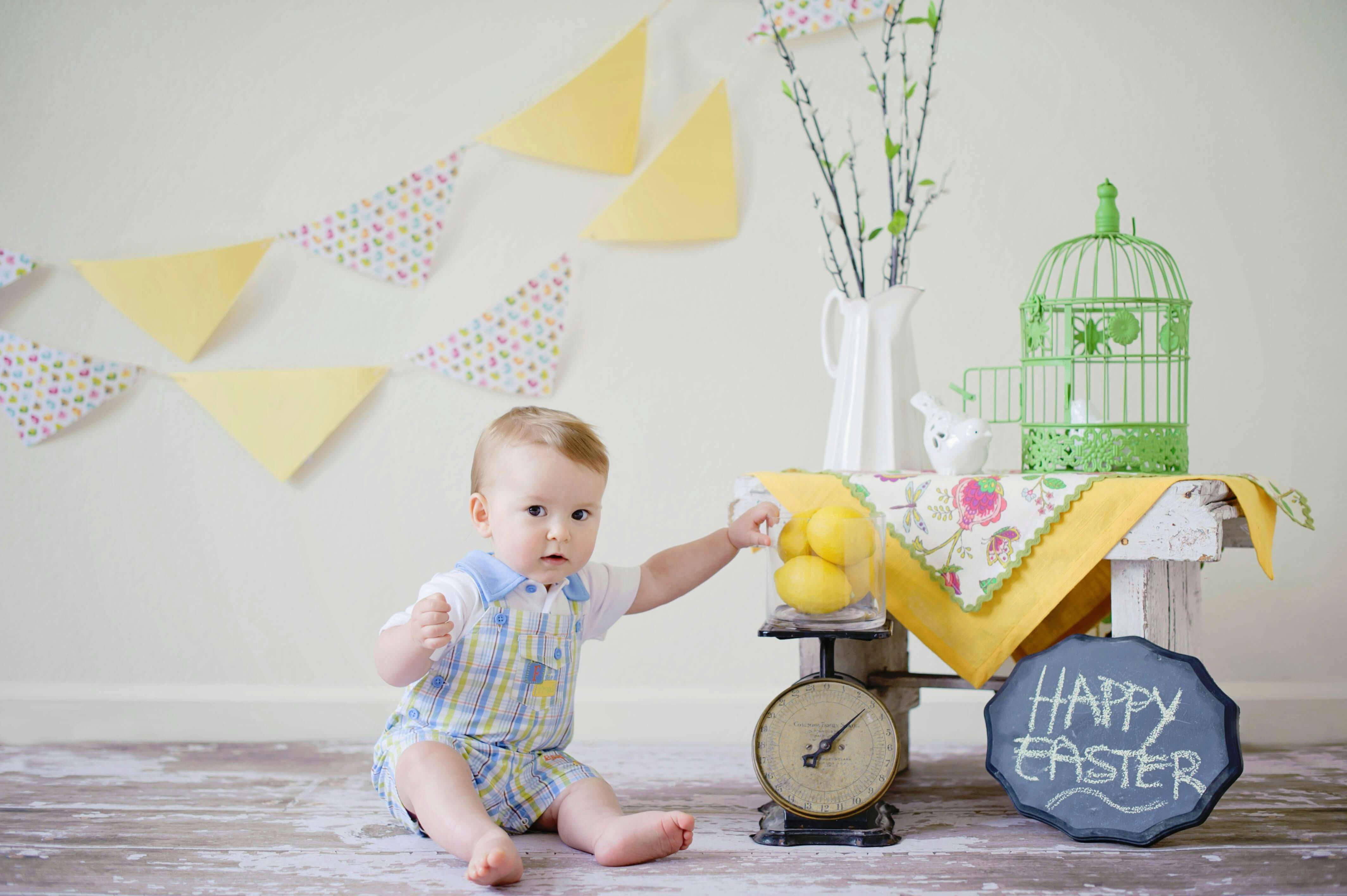 Baby boy reaching for table.