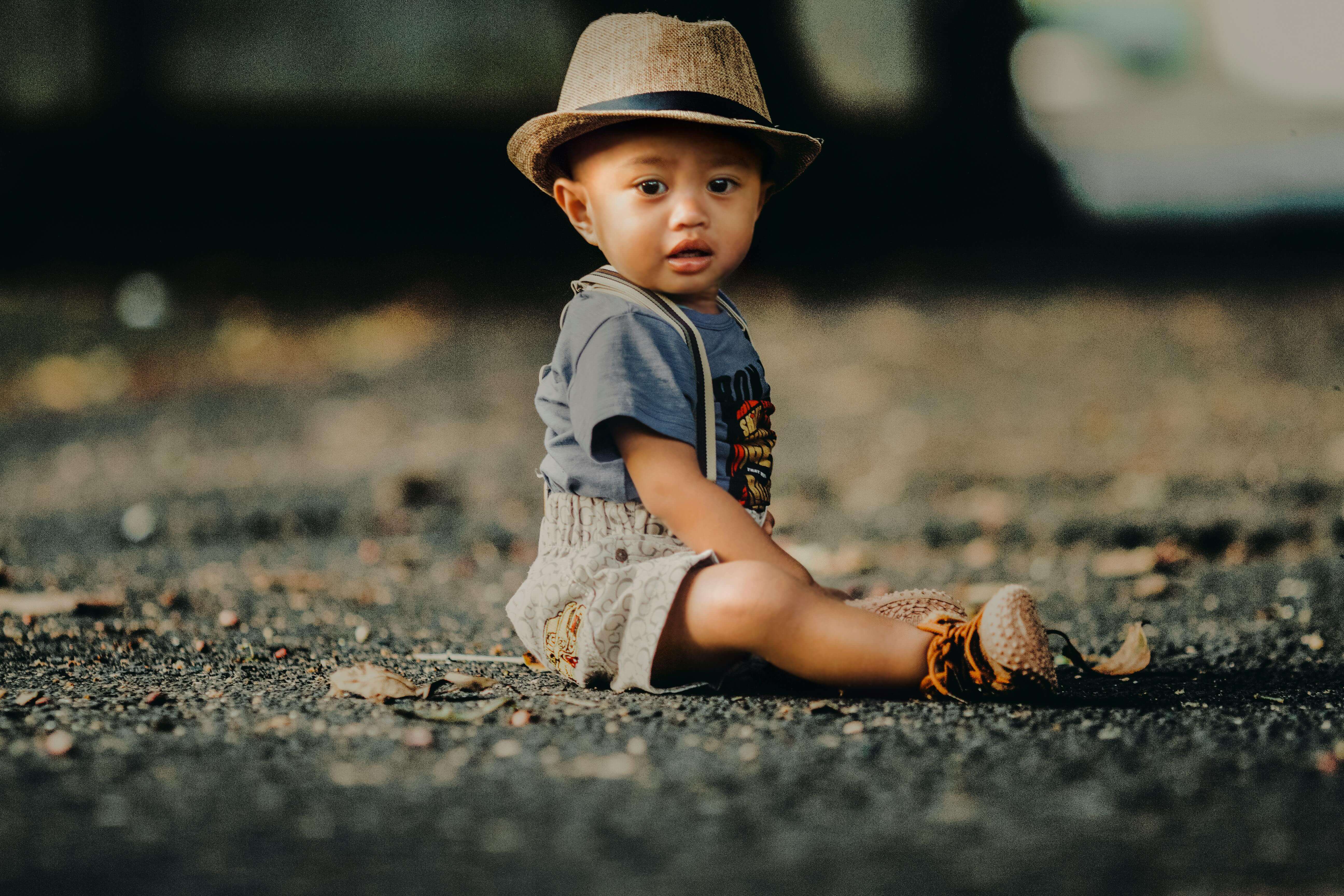 Baby boy sitting on lawn.