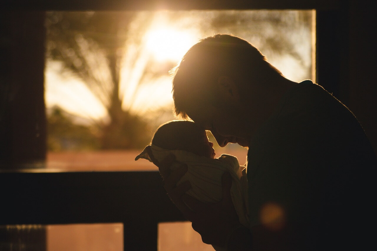 Dad holding Infant Forehead to forehead