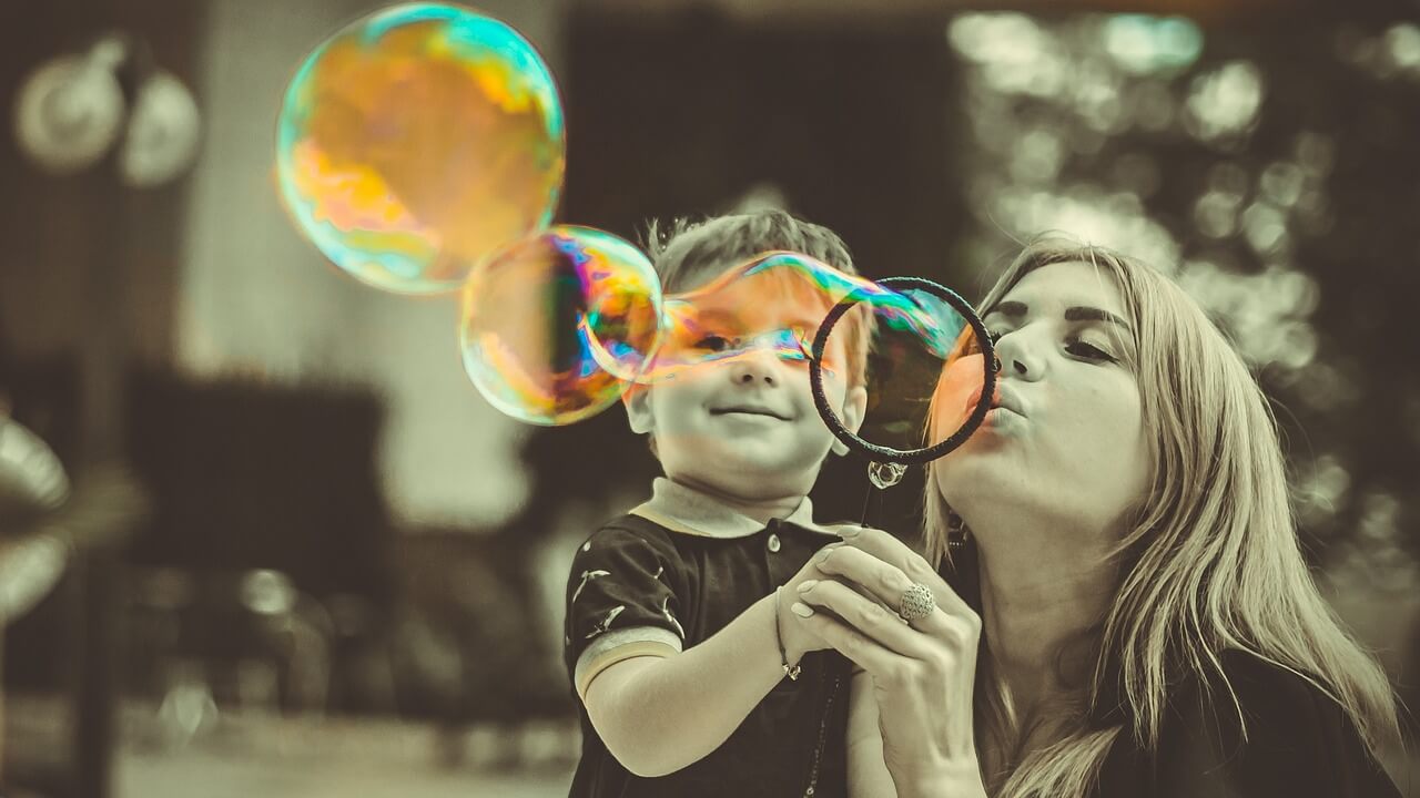 Mom and boy blowing bubbles.