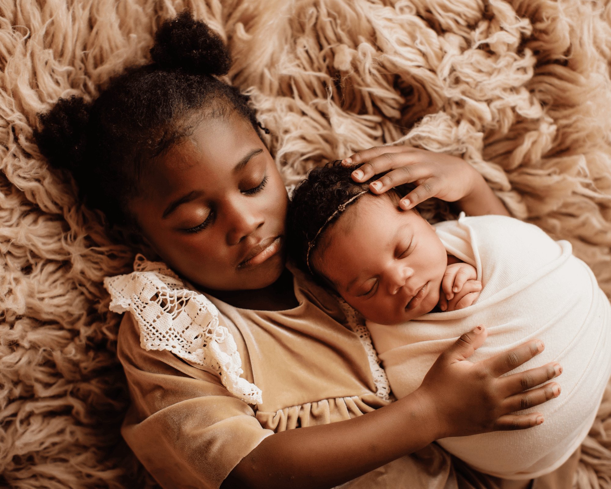 Little girl sleeping with her sister.