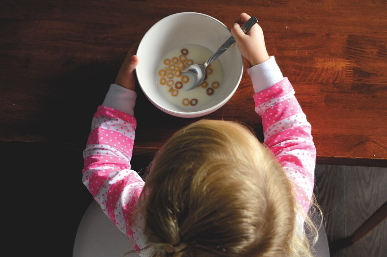 Child eating a bowl of cereal.