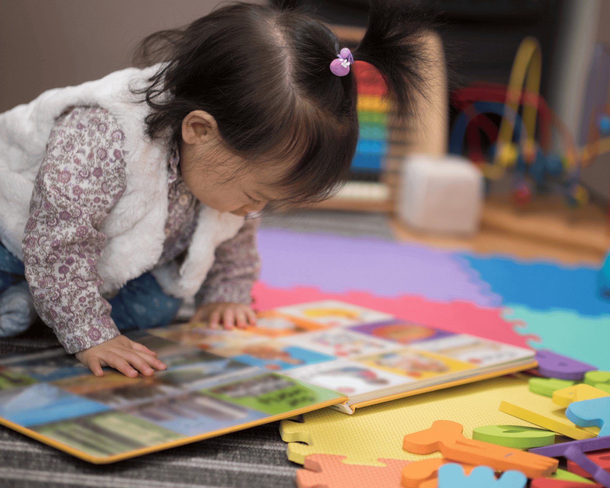 Girl reading picture book.