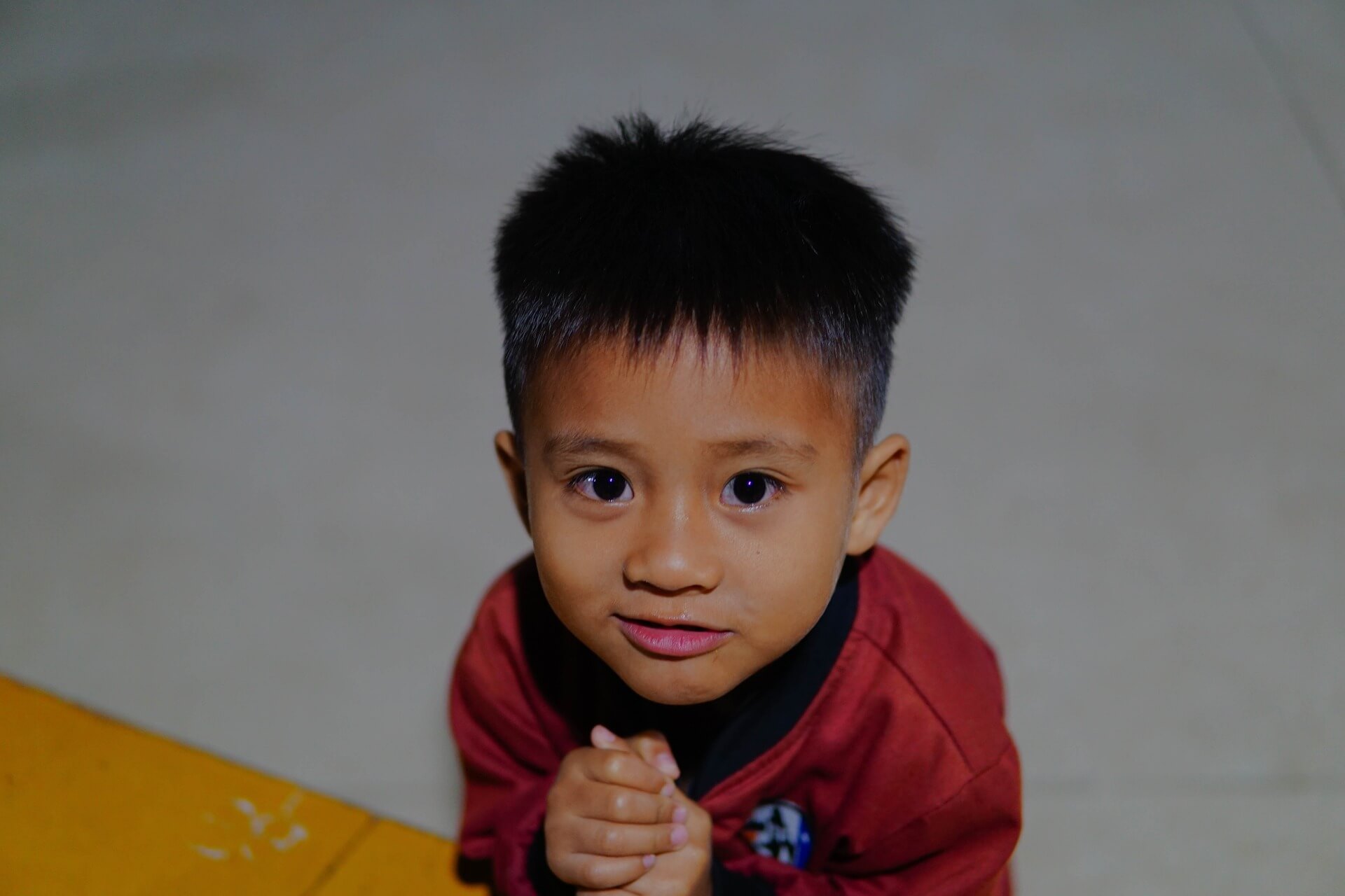 Toddler Looking at Camera and Smiling