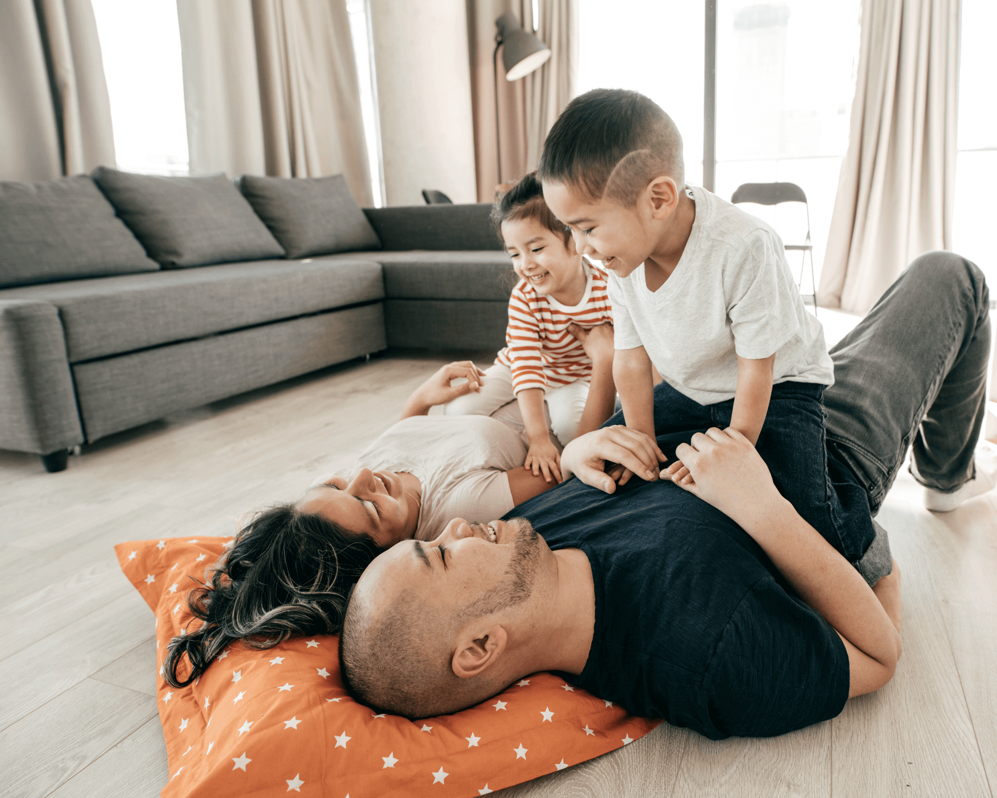 Parents on floor with 2 preschoolers