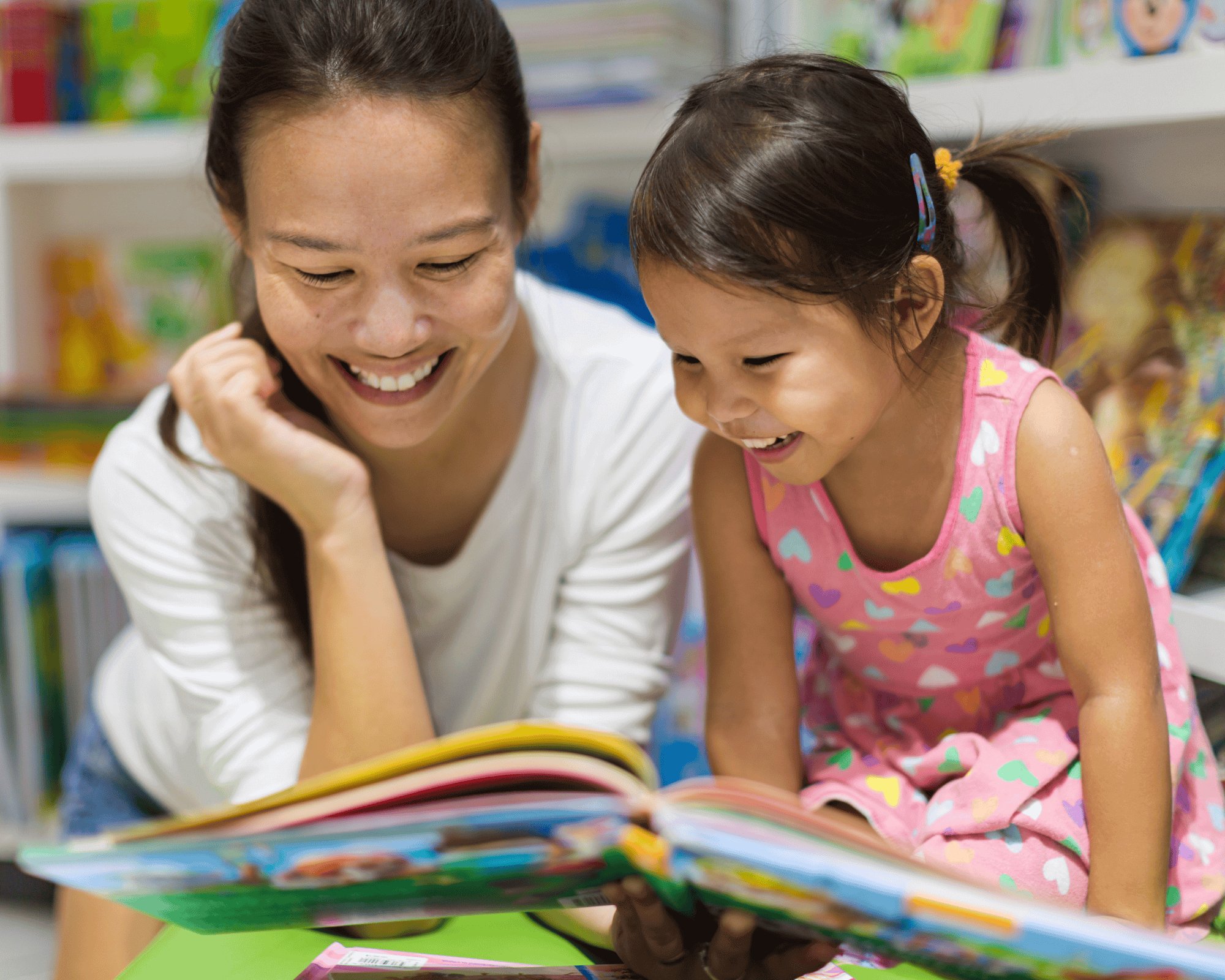 Mom and daughter reading a book together.