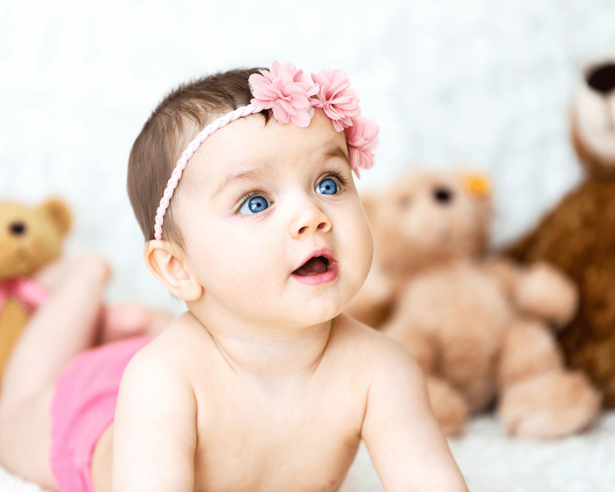 Newborn girl looking up at something. 