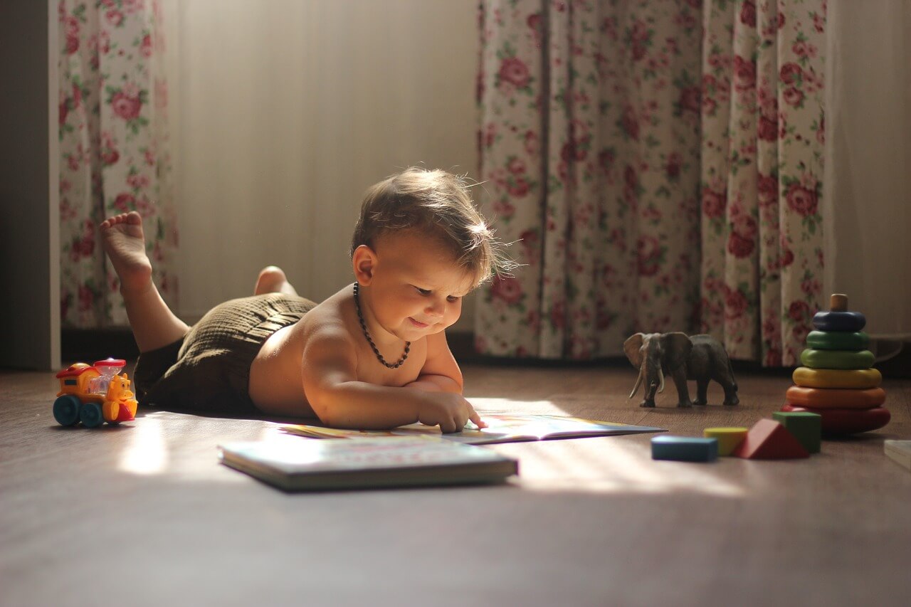 Toddler on the floor colouring.