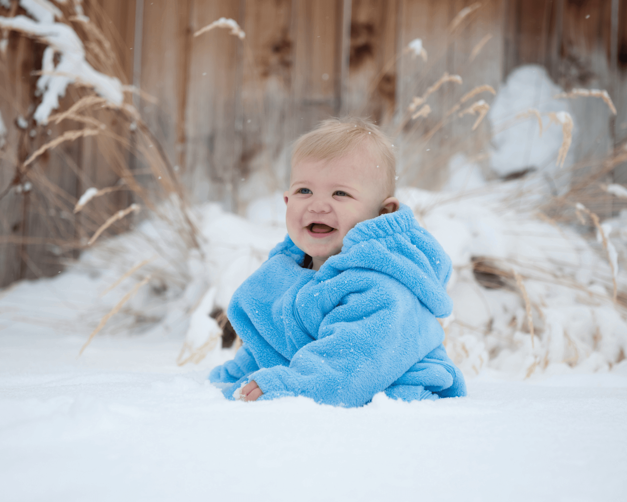 Baby boy sitting out in the snow